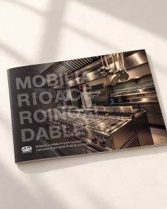 Diseño de dossier comercial para Sanabria y Marín con portada fotográfica de una cocina profesional de acero inoxidable. 