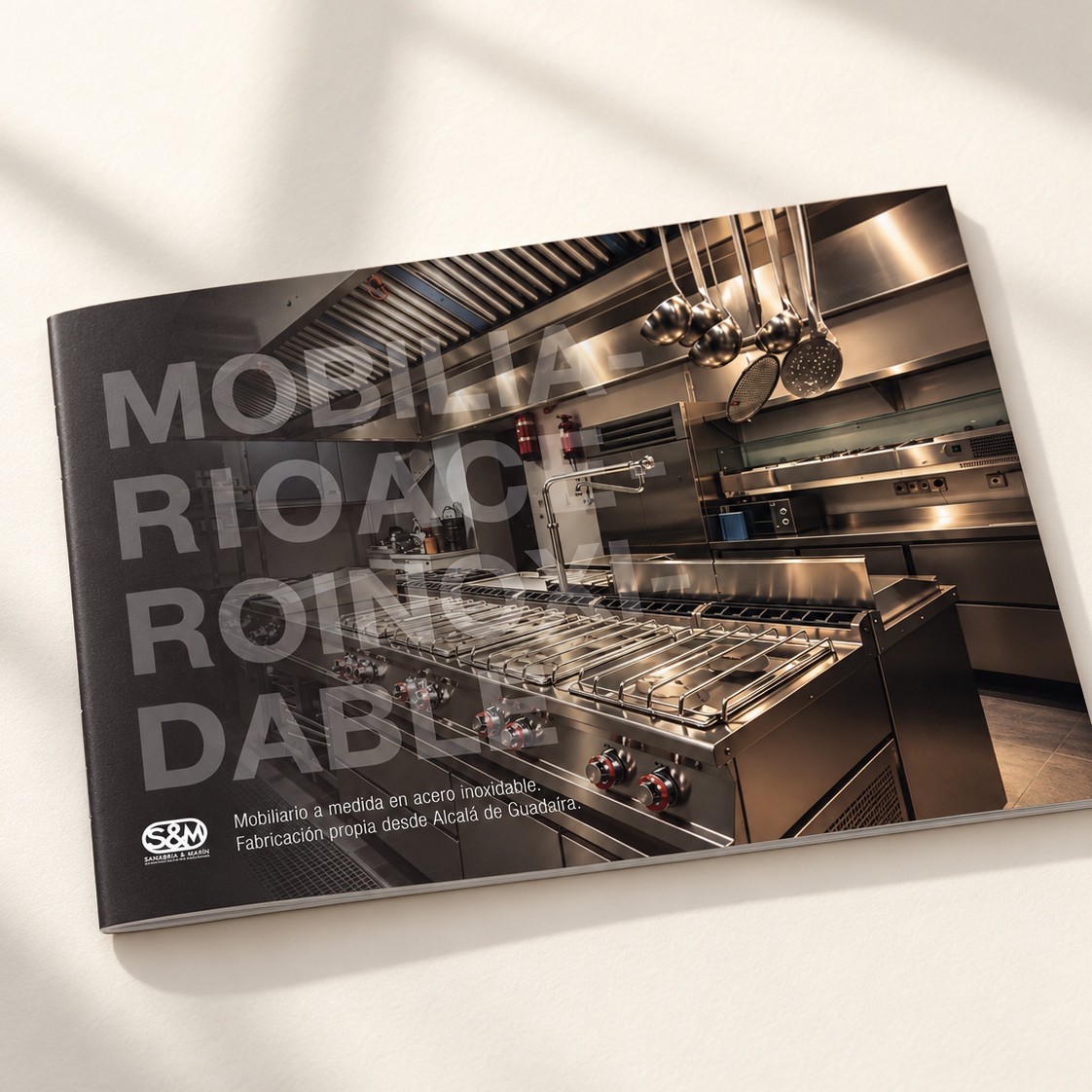 Diseño de dossier comercial para Sanabria y Marín con portada fotográfica de una cocina profesional de acero inoxidable.